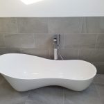Modern bathroom with a modern white bathtub.