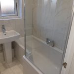 Modern bathroom with right angled walk in shower.